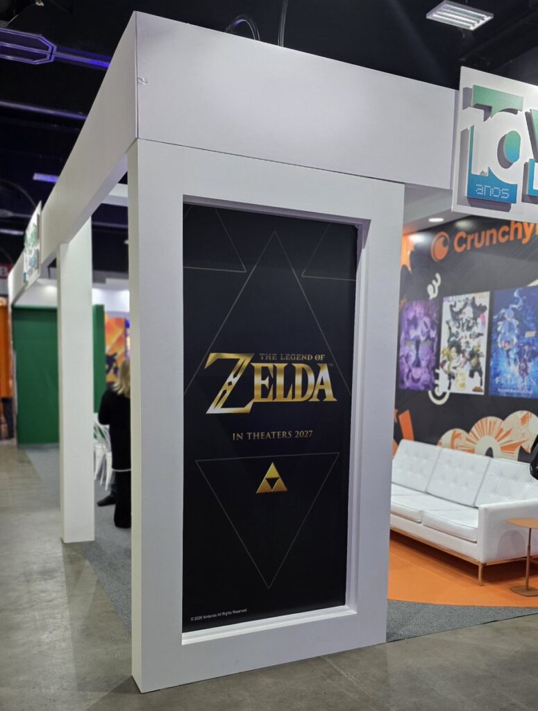 The Legend of Zelda Movie Promotional Material Appears at LicensingCon LATAM 2026 2 The Legend of Zelda live-action movie promotional display at LicensingCon LATAM 2026 featuring the gold Zelda logo and Triforce