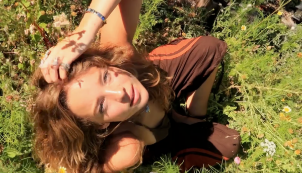Bo Bragason Opens Up About Filming The Legend of Zelda Movie in New Zealand 2 Bo Bragason relaxing among wildflowers in a sunlit meadow