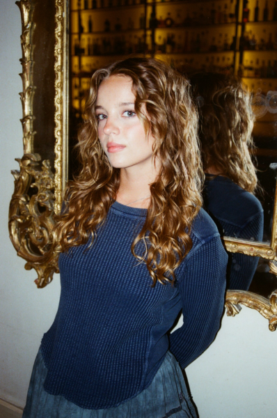 Bo Bragason Opens Up About Filming The Legend of Zelda Movie in New Zealand 4 Bo Bragason posing beside an ornate gold mirror in a blue top