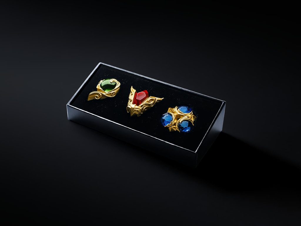 Ocarina of Time Remake Pre-Order Bonuses: Every Regional Exclusive So Far 5 Kokiri’s Emerald, Goron’s Ruby, and Zora’s Sapphire Spiritual Stone replicas displayed in a black collector box for the Ocarina of Time Remake pre-order bonus.