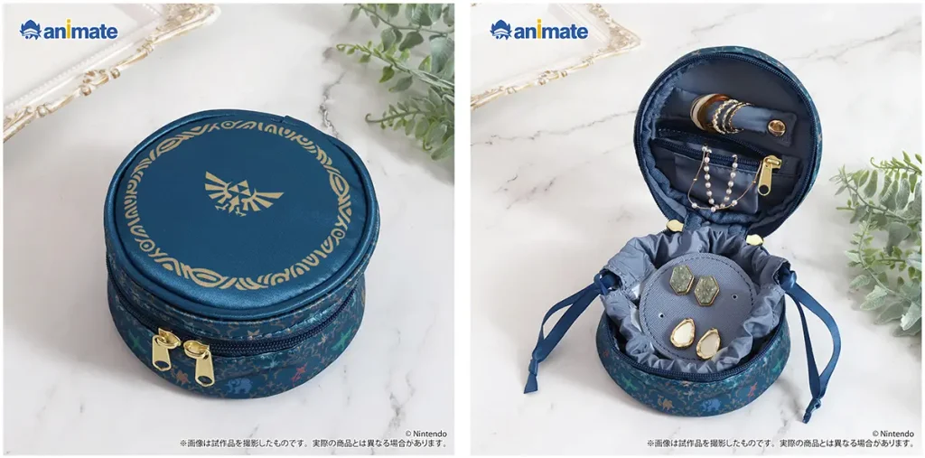 Animate Launches New Zelda Merchandise With Korok Accessories and Navi Bonuses 3 Blue Zelda accessory pouch shown closed with a gold Hylian crest and open with jewelry inside.