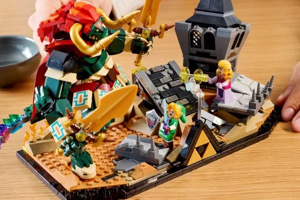 LEGO Ocarina of Time Final Battle set displayed on a table, with hands adjusting the Ganon figure and castle scene. LEGO Ocarina of Time Final Battle set displayed on a table, with hands adjusting the Ganon figure and castle scene.