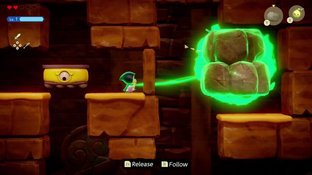 In der seitlichen Ansicht bindet Zelda die gestapelten Felsbrocken beiseite.