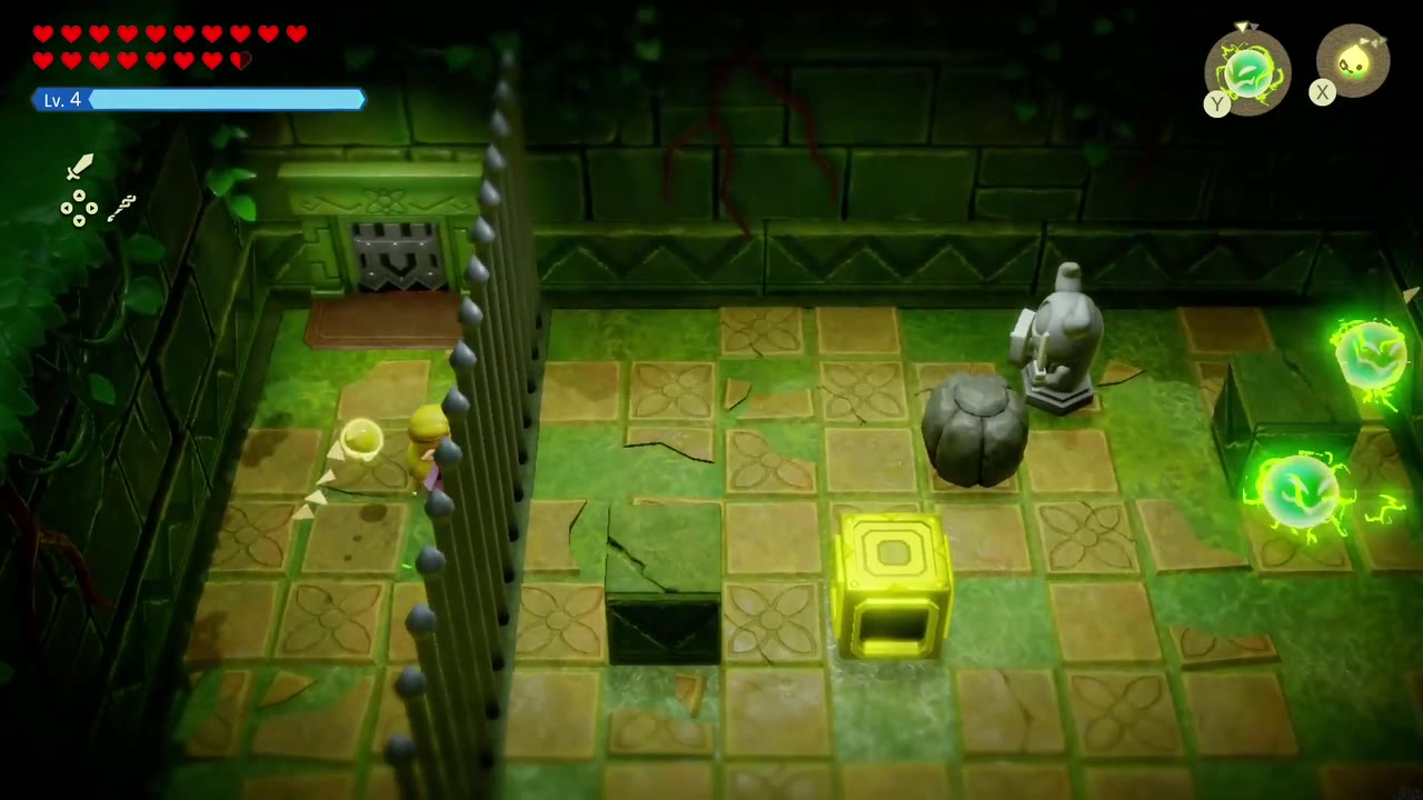 From behind the bars Zelda Binds a boulder and pulls it toward the yellow block. From behind the bars Zelda Binds a boulder and pulls it toward the yellow block.