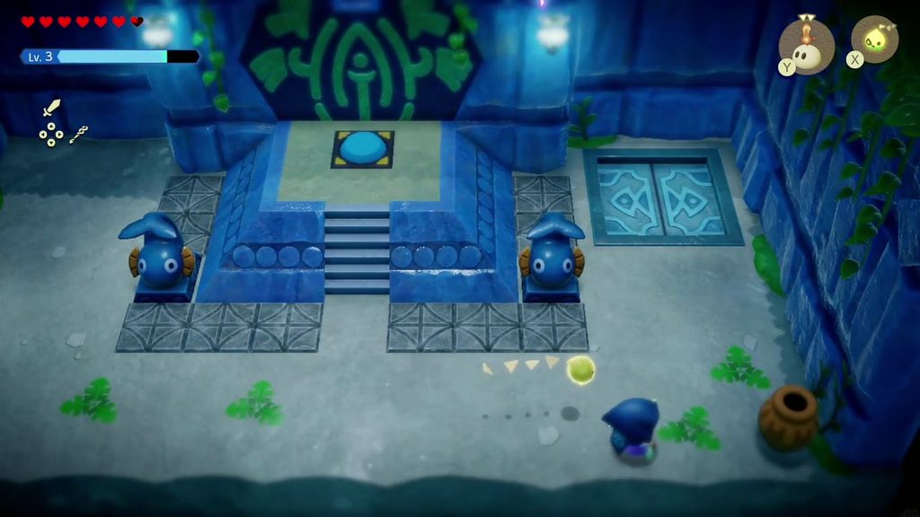 The next room: a light-blue floor switch sits on top of the steps between two fish statues.