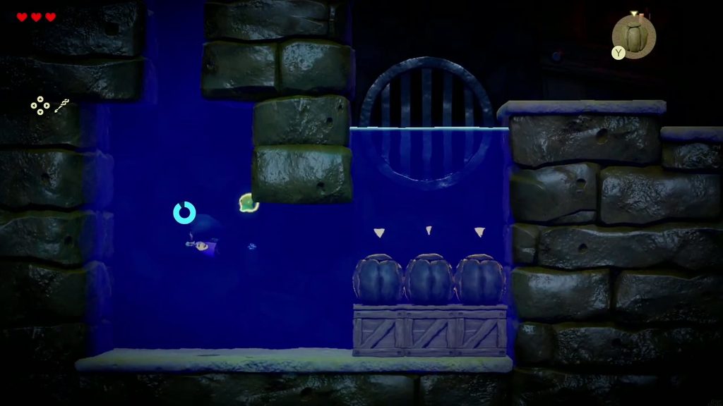 Boulders hold the wooden boxes underwater so Zelda can swim through to the grate passage