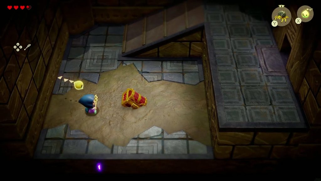 A treasure chest lies half-buried in a sand-floored room of the Suthorn Ruins