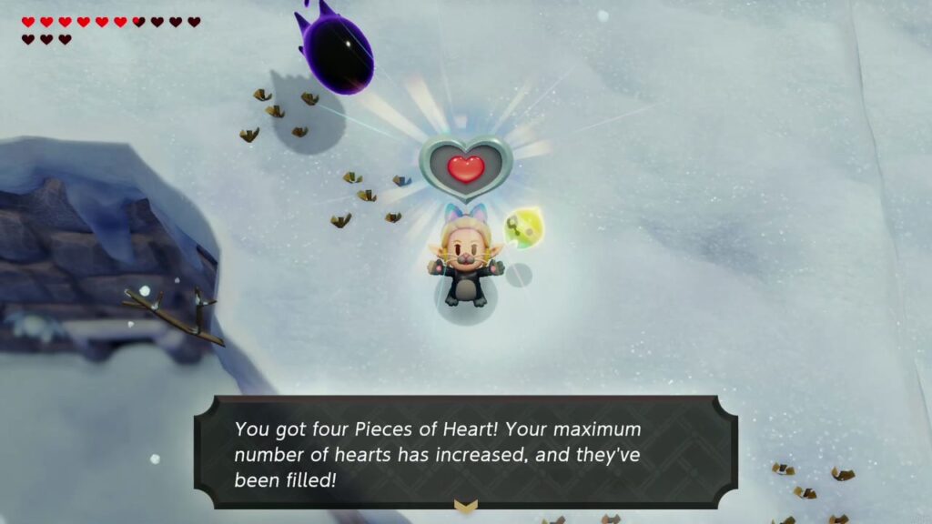 Zelda hält das Herzteil oben auf der Klippe hoch; auf der Schachtel steht, dass vier Herzteile ihre maximale Herzanzahl erhöht haben.