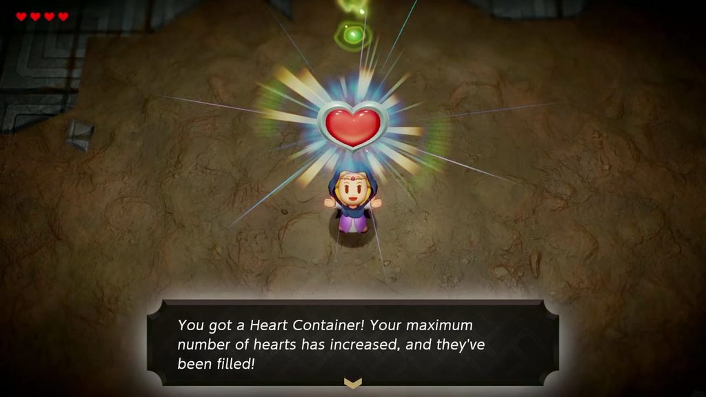 Zelda holds up the Heart Container earned by defeating the Seismic Talus