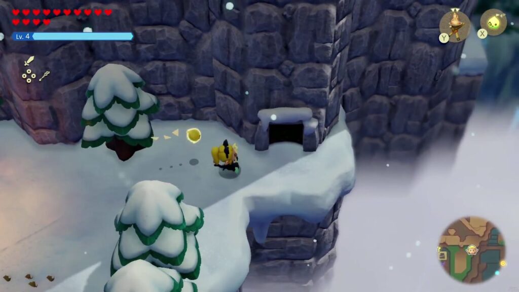 Hebra Mountain: A Rift on Holy Mount Lanayru - The Legend of Zelda: Echoes of Wisdom Walkthrough 121 Zelda heads for the cave entrance in the rock face past the snowy forest clearing on Hebra Mountain.