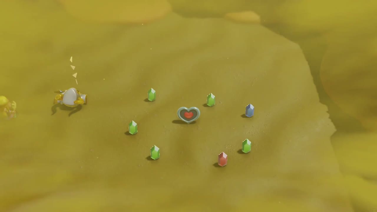 A Rift in the Gerudo Desert - The Legend of Zelda: Echoes of Wisdom Walkthrough 128 The defeated Lanmola leaves a Piece of Heart inside a ring of rupees on the Gerudo Desert sand.