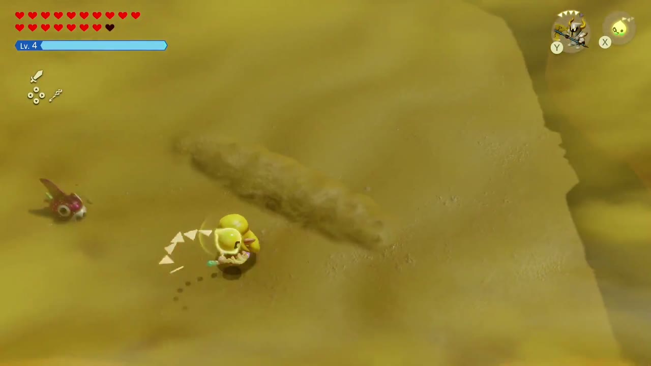 A trail of churned sand shows the Lanmola moving underground beside Zelda. A trail of churned sand shows the Lanmola moving underground beside Zelda.
