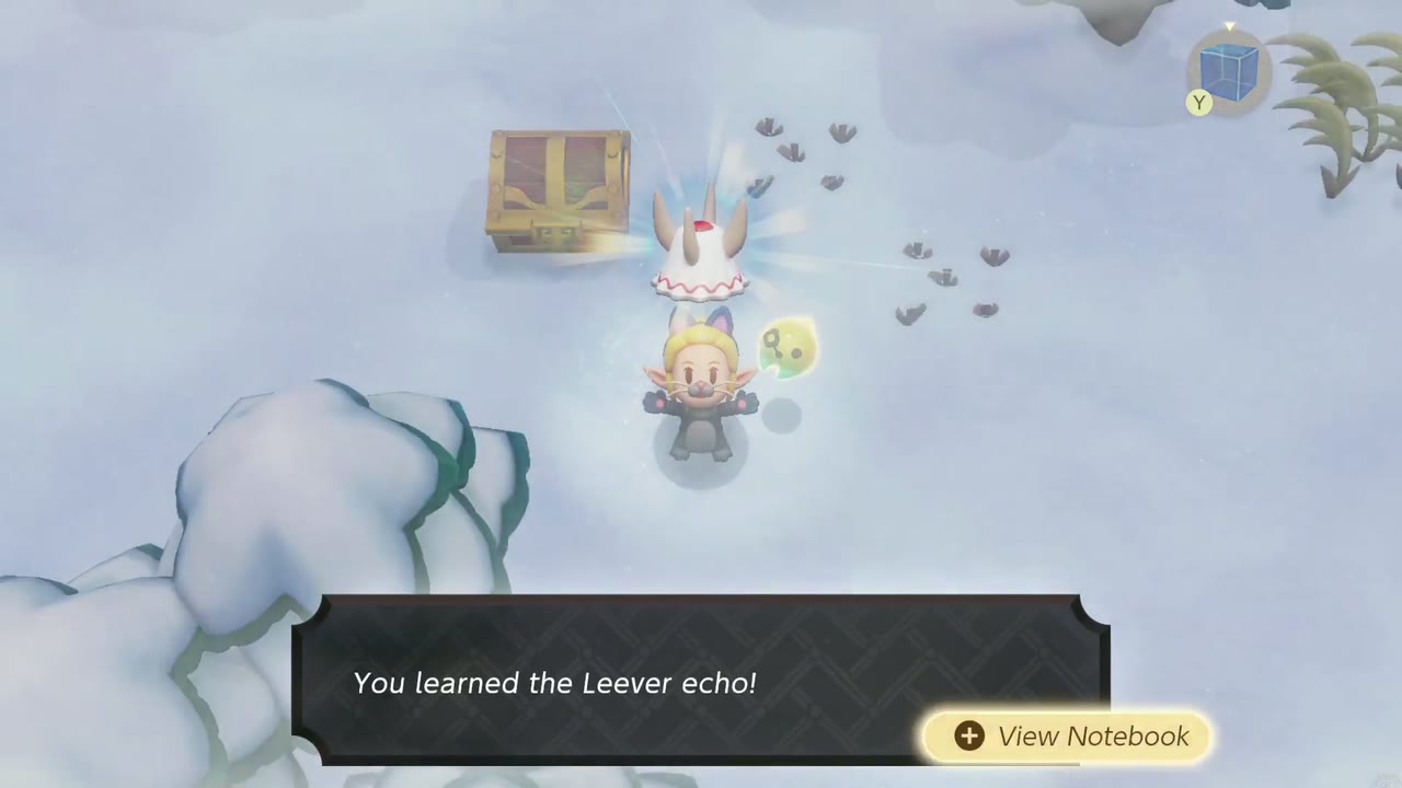 Zelda aprende o eco de Leever em um campo de neve aberto ao lado de um baú de tesouro na Montanha Hebra. Zelda aprende o eco de Leever em um campo de neve aberto ao lado de um baú de tesouro na Montanha Hebra.