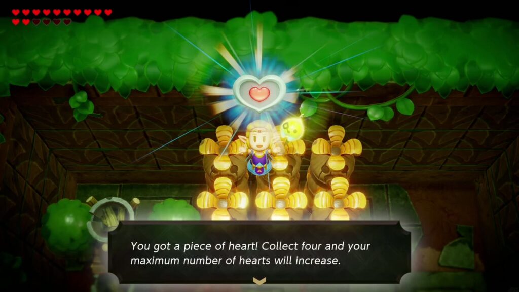 Zelda hält das Herzteil obenauf. Deku Totems: „Du hast ein Stück Herz bekommen!“