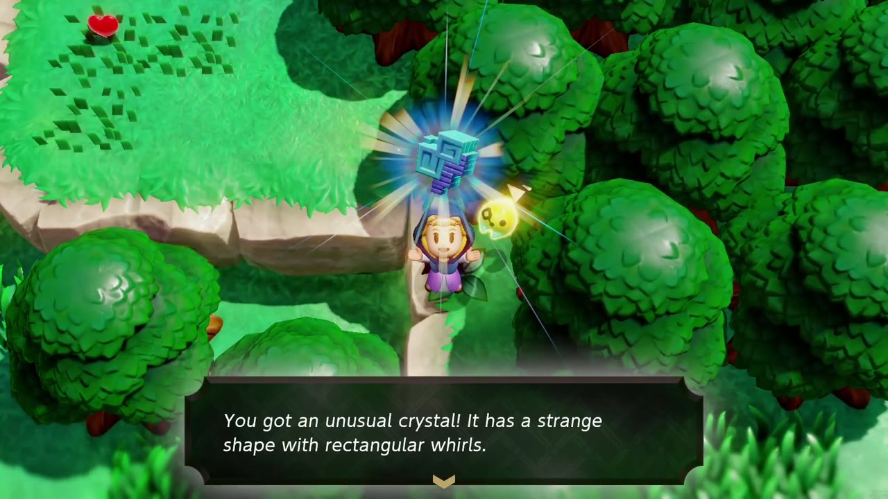 Zelda holds up an unusual crystal on a narrow path between dense trees and a grassy ledge in Hyrule Field