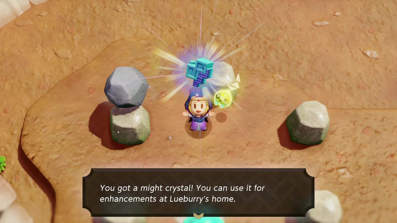 Zelda holds a might crystal overhead on a dirt plateau between ring stones, a grey boulder moved aside, text box below