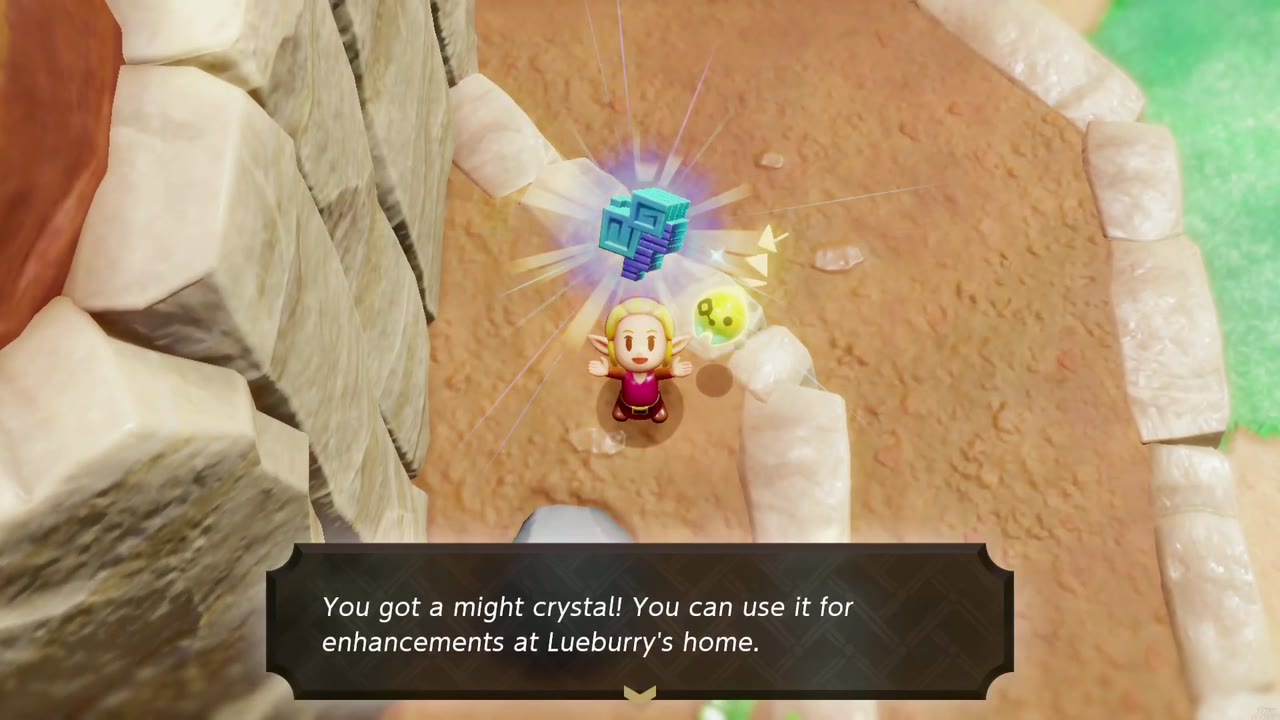 Zelda holds a might crystal overhead on a sandy red-rock canyon path, with the lifted gray boulder beside her.