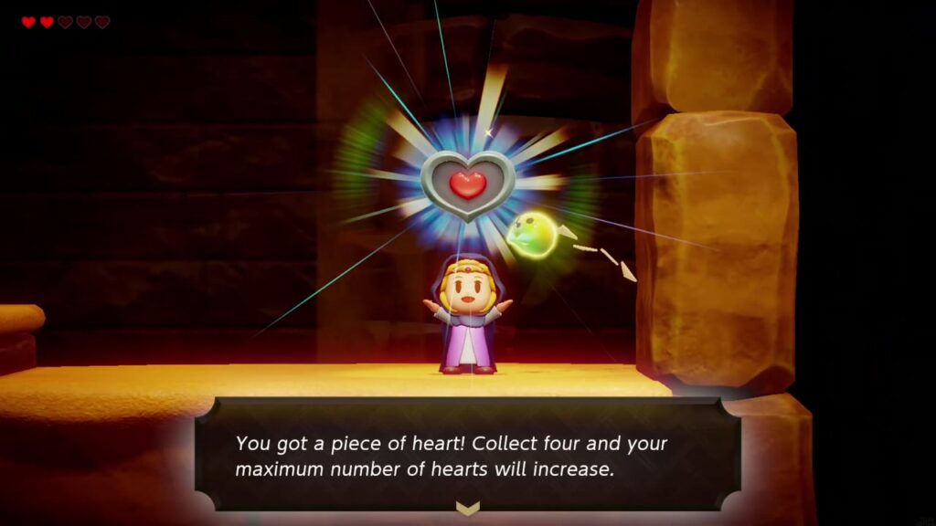 Zelda hält das Herzteil am Ende des Ganges unter der Luke hoch.