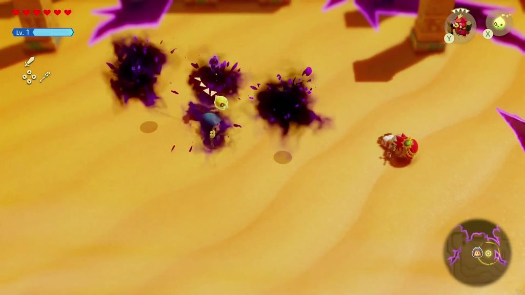 A Rift in the Gerudo Desert - The Legend of Zelda: Echoes of Wisdom Walkthrough 15 Dark rift monsters burst from the sand around a red-helmeted Gerudo warrior near the ruins.