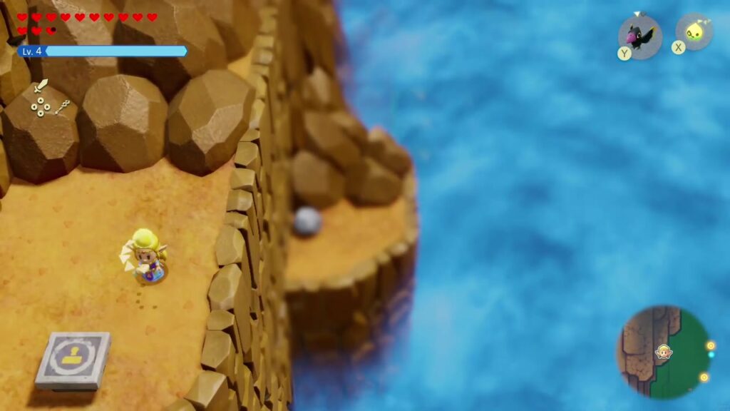 The Rift on Eldin Volcano - The Legend of Zelda: Echoes of Wisdom Walkthrough 89 A stamp stand on the sandy sea cliffs of Eldin Volcano near the Glide Path Trailblazer finish.