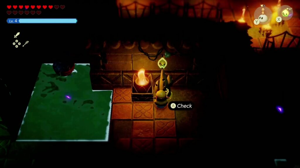 Faron Temple Dungeon - The Legend of Zelda: Echoes of Wisdom Walkthrough 6 Zelda checks a Waypoint statue beside a lit brazier in the dark torch rooms of Faron Temple.