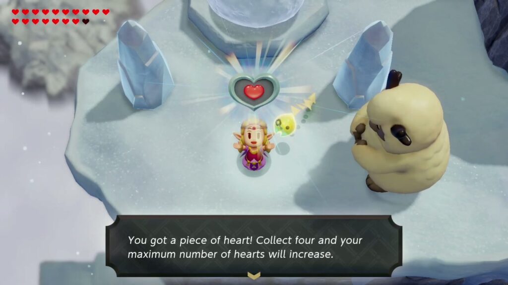 Hebra Mountain: A Rift on Holy Mount Lanayru - The Legend of Zelda: Echoes of Wisdom Walkthrough 115 Zelda holds up the Piece of Heart Condé gives as the Snowball Magic reward on Hebra Mountain.
