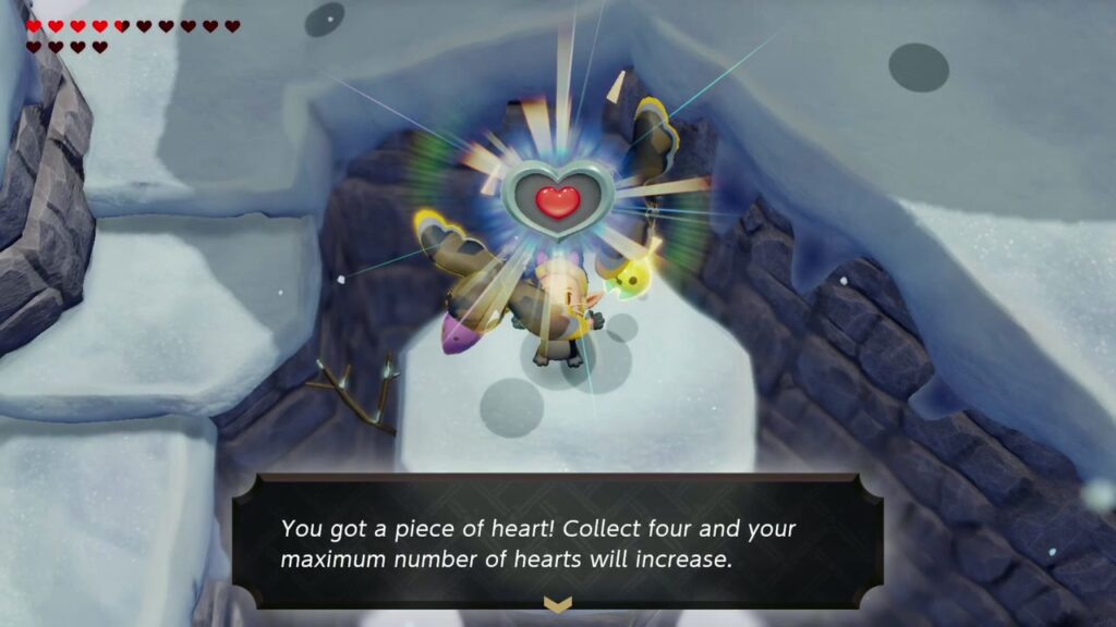 Zelda hält das Herzteil auf der Schneesäule hoch, daneben die Aufschrift „Du hast ein Herzteil erhalten!“.