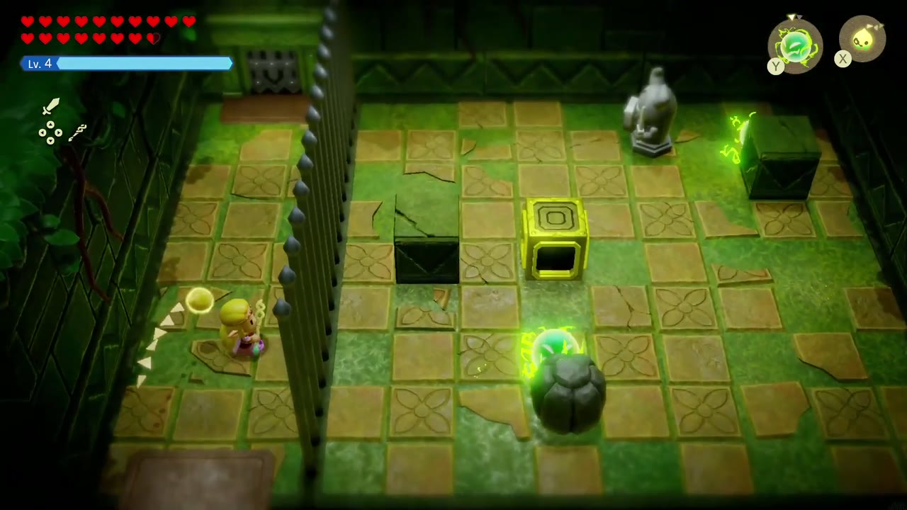 Zelda stands behind spiked bars in the green-lit statue room as a Spark circles a boulder. Zelda stands behind spiked bars in the green-lit statue room as a Spark circles a boulder.
