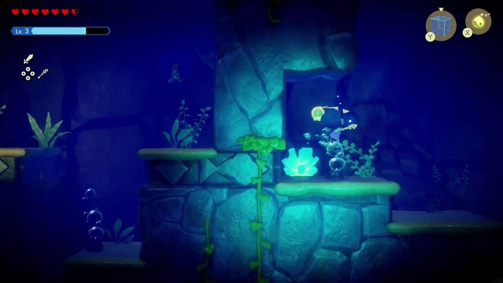Zelda swims past glowing blue coral in the dark underwater passage beneath the Jabul Ruins hub.