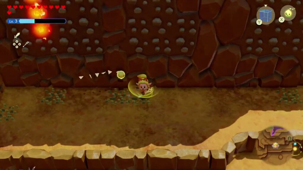 The Rift on Eldin Volcano - The Legend of Zelda: Echoes of Wisdom Walkthrough 15 Zelda walks below the Torch Slug wall on Eldin Volcano Trail, with a fire trail at top left.