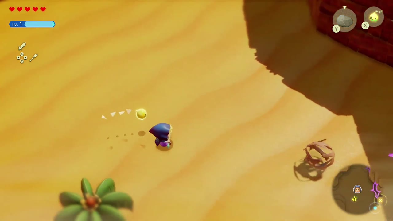 Elusive Tumbleweeds - The Legend of Zelda: Echoes of Wisdom Walkthrough 5 Zelda walks toward a tumbleweed rolling on the sand below the rocky ledge east of Gerudo Town.