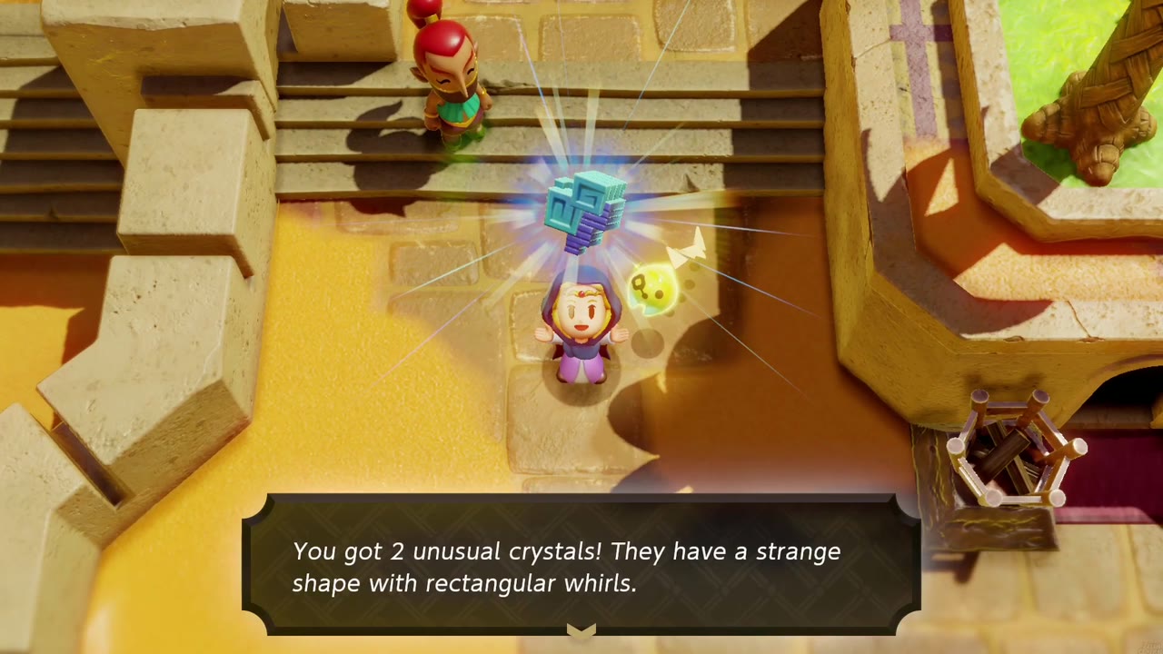 Zelda holds up 2 unusual crystals on the sandstone stairs in Gerudo Town, the tumbleweed fan standing behind her