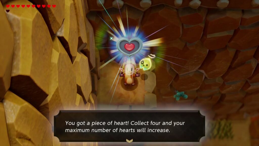 Zelda hält das Herzteil auf dem Felsvorsprung des Vulkanpfads hoch, zusammen mit der Aufschrift „Du hast ein Herzteil erhalten!“.