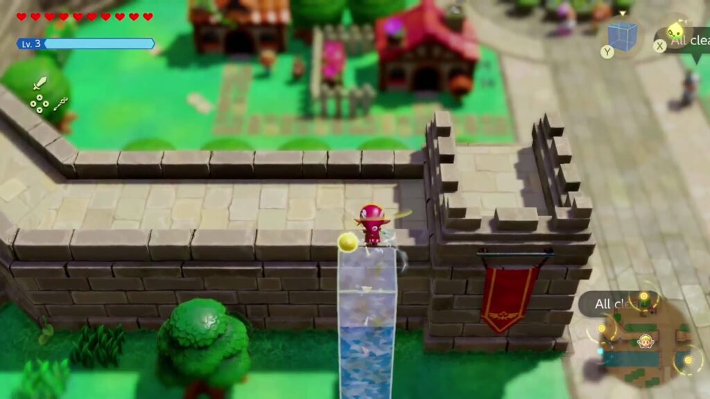 Zelda schwimmt von einem Grasstreifen über einen Wasserblock auf die äußere Mauer der Burgstadt.