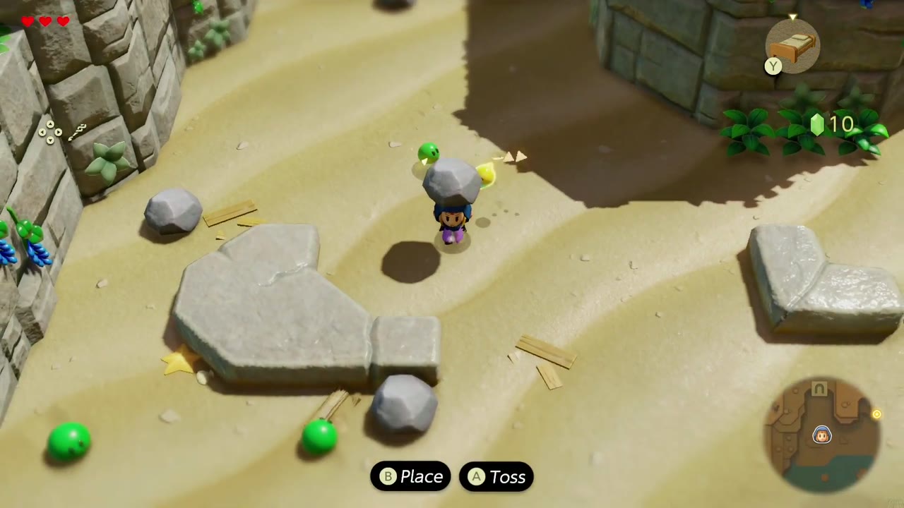 Zelda levanta uma pedra para atirar nos Zols verdes na praia de Suthorn. Zelda levanta uma pedra para atirar nos Zols verdes na praia de Suthorn.
