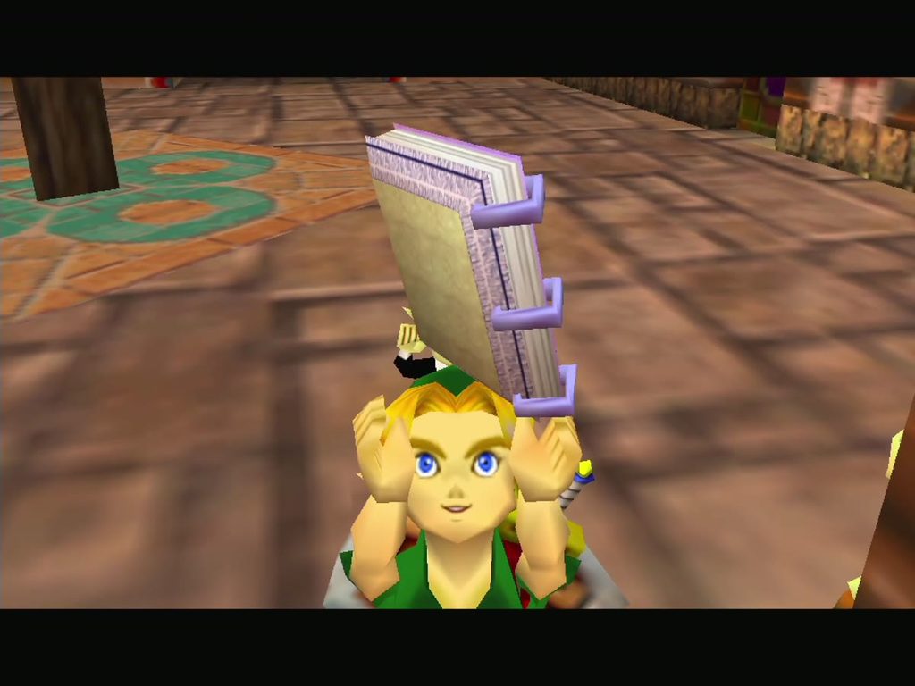 Link holds up the Bombers' Notebook, given on the Nintendo 64 version after leaving the hideout. Link holds up the Bombers' Notebook, given on the Nintendo 64 version after leaving the hideout.