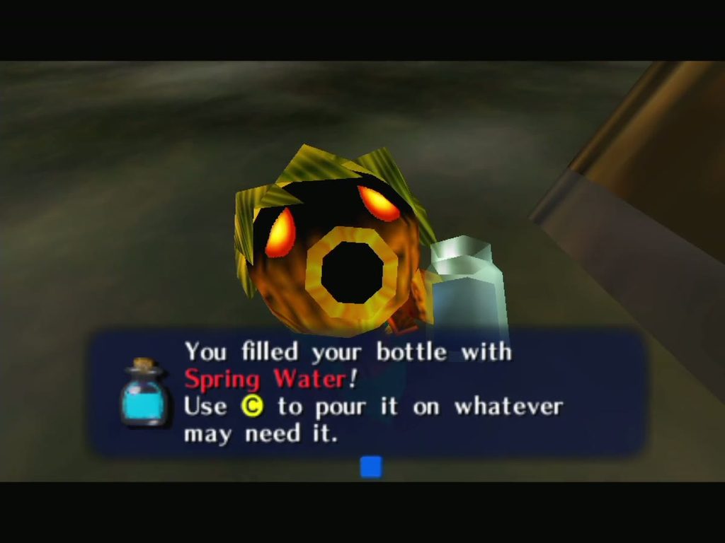 Deku Link holds up the Bottle after filling it with Spring Water from the cave pool.