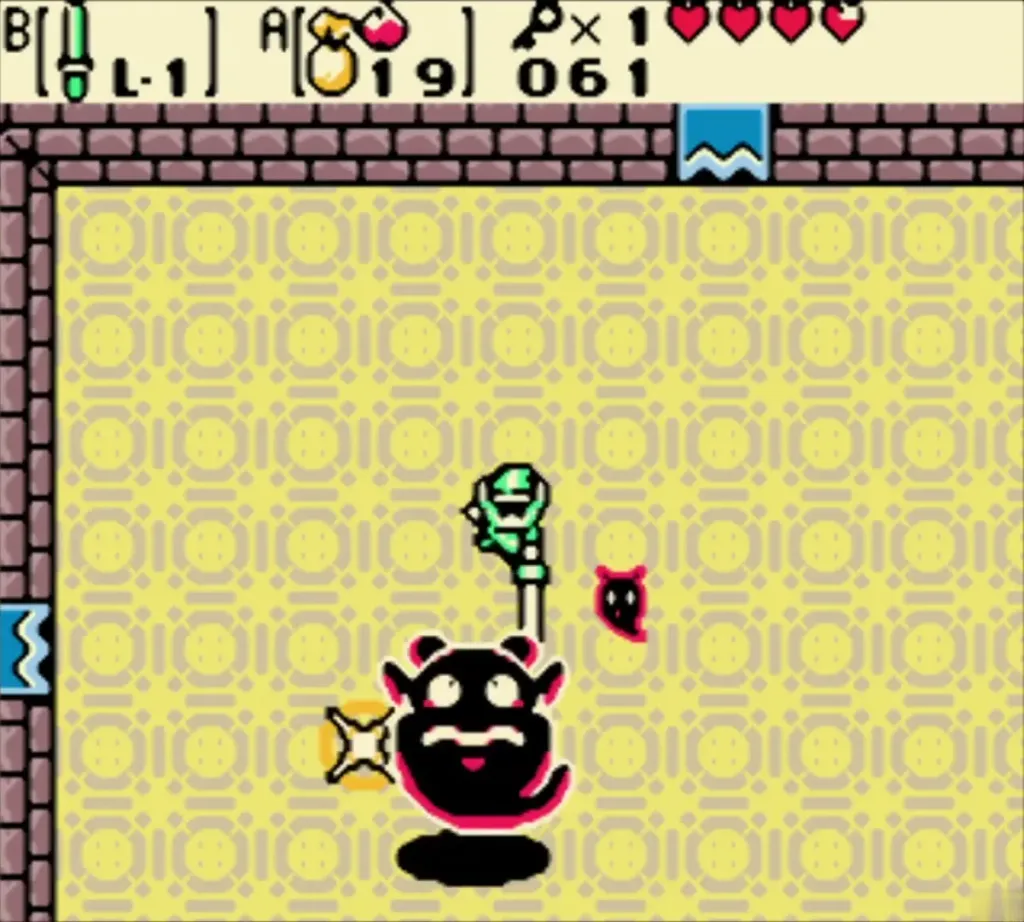 Link striking Giant Ghini with his sword while a small ghost hovers nearby