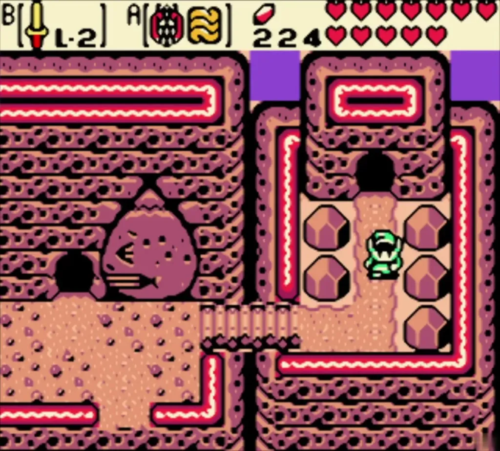 Link in the past pink ridge beside the stone Goron head with rock blocks nearby