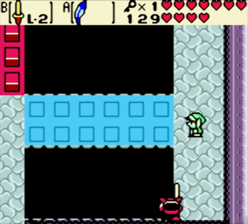 Link beside the raised blue blocks over the pit with a spiked enemy below Link beside the raised blue blocks over the pit with a spiked enemy below
