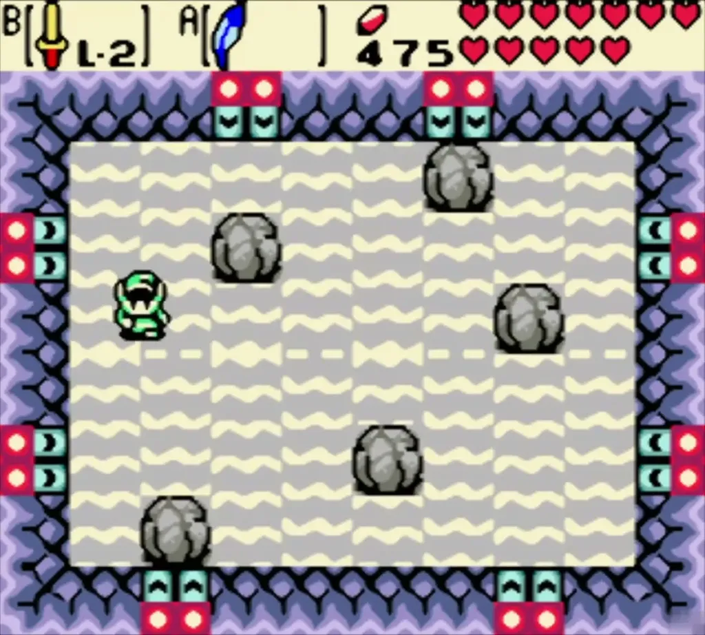 Link in the Goron bomb-dodge arena with a wavy sand floor and grey boulders Link in the Goron bomb-dodge arena with a wavy sand floor and grey boulders