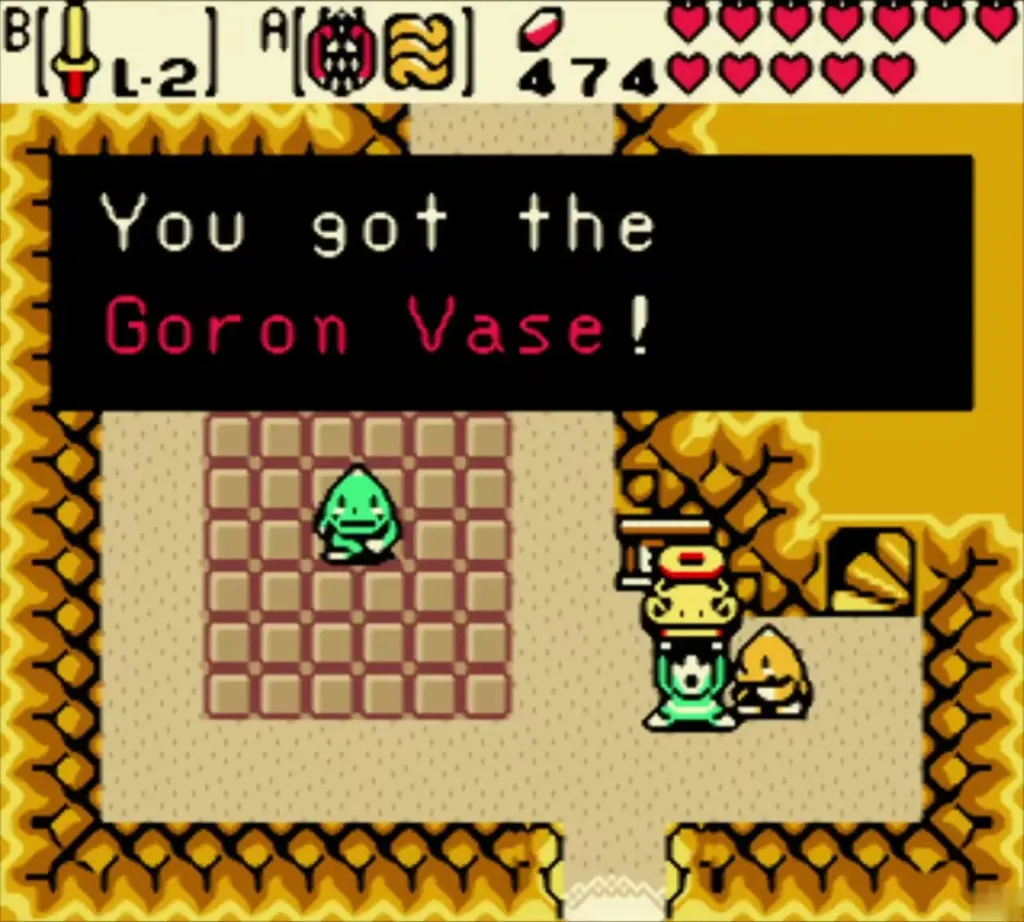Link holding up the Goron Vase in the cave on the Rolling Ridge, the box reading You got the Goron Vase Link holding up the Goron Vase in the cave on the Rolling Ridge, the box reading You got the Goron Vase