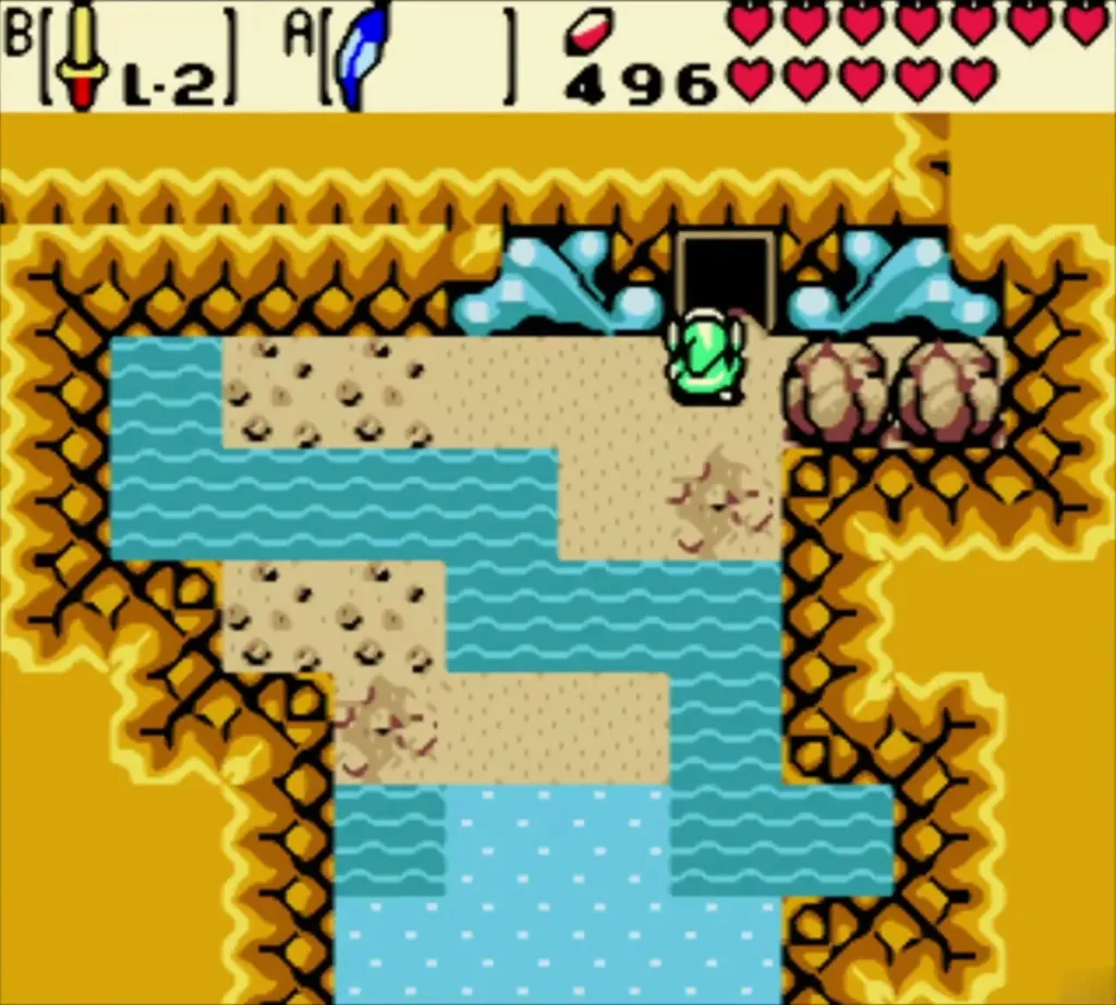 Link at the dark doorway of Mermaid's Cave beside a blue water channel Link at the dark doorway of Mermaid's Cave beside a blue water channel