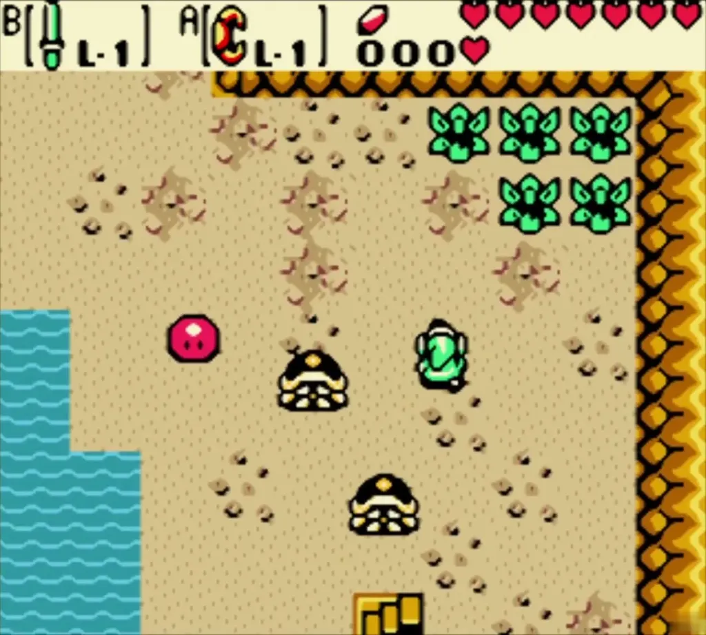 Link facing sand enemies and a red blob in the sandy cave Link facing sand enemies and a red blob in the sandy cave
