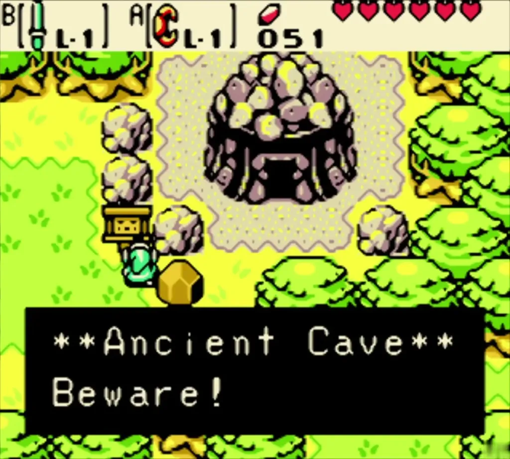 The Ancient Cave sign with its Beware message beside the boulders The Ancient Cave sign with its Beware message beside the boulders