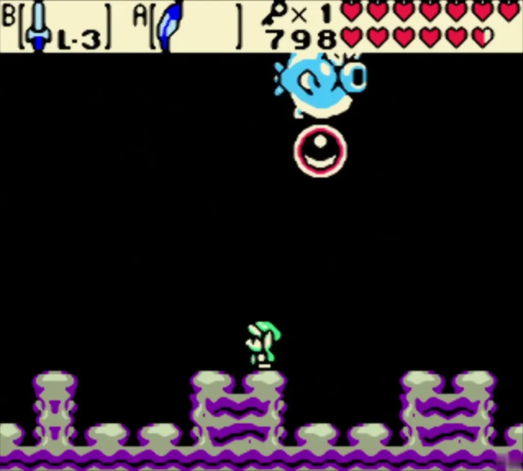 Angler Fish above a red ring attack while Link stands on the ledge below