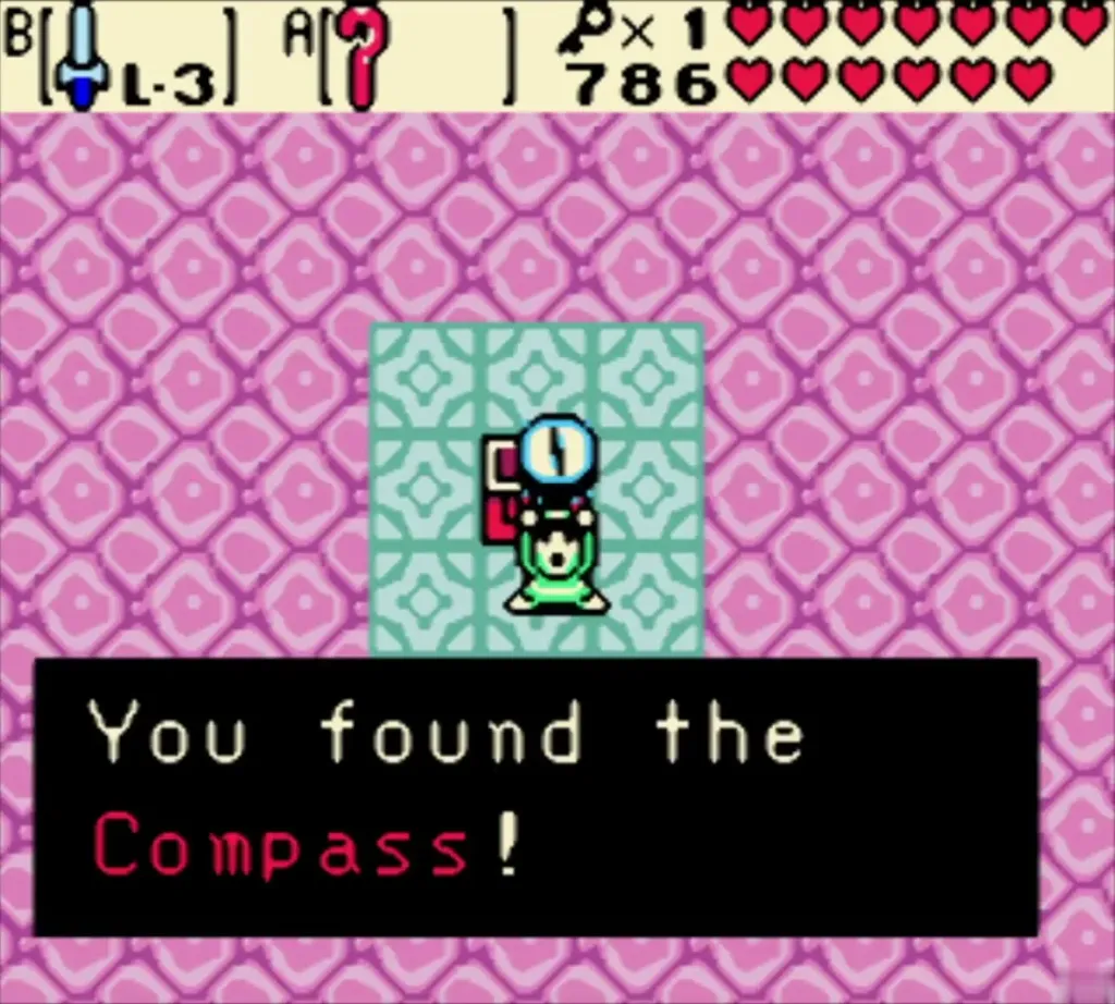 Link holding up the Compass on a teal tile pad with the You found the Compass message