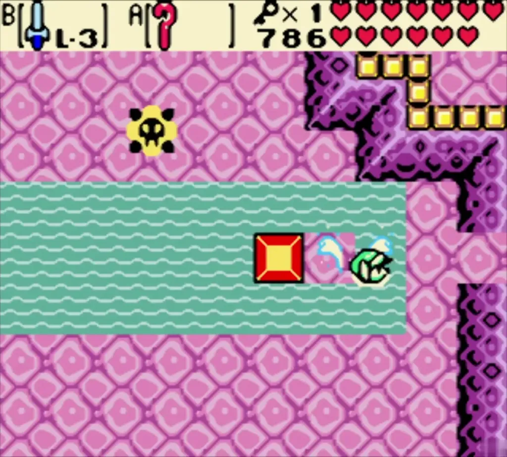Red switch and grey button at the edge of the teal water strip in Jabu-Jabu's Belly