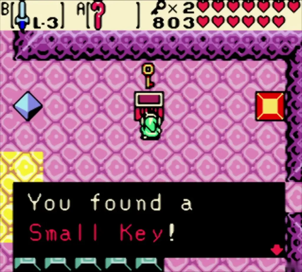 Link holding up a Small Key beside a chest in a pink room of Jabu-Jabu's Belly