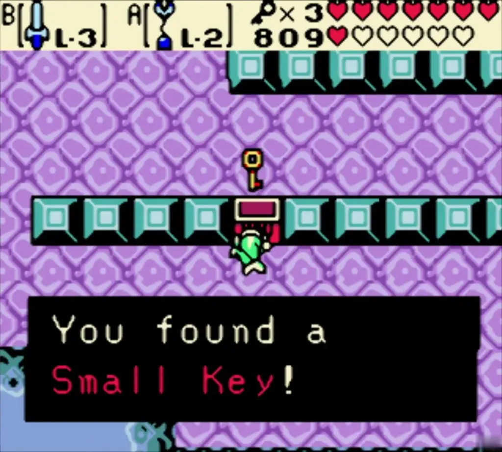 Link holding up a Small Key above a teal block row chest in Jabu-Jabu's Belly